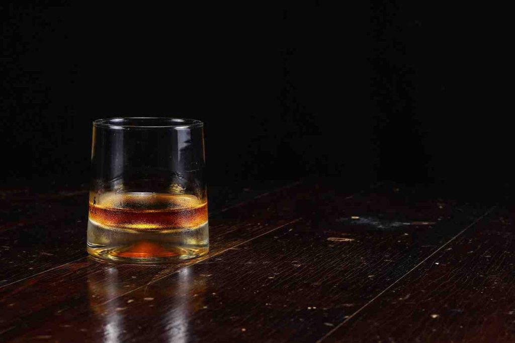 Whiskey glass, symbolizing the physical addiction to alcohol and its withdrawal timeline.