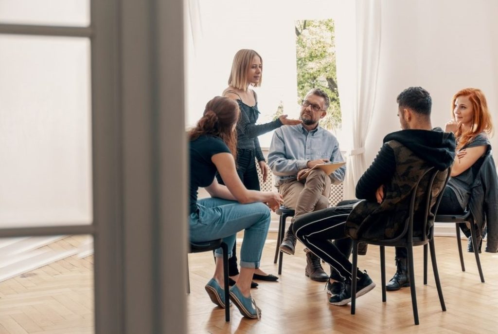Diverse adults in a supportive alcohol recovery counselling session in Australia